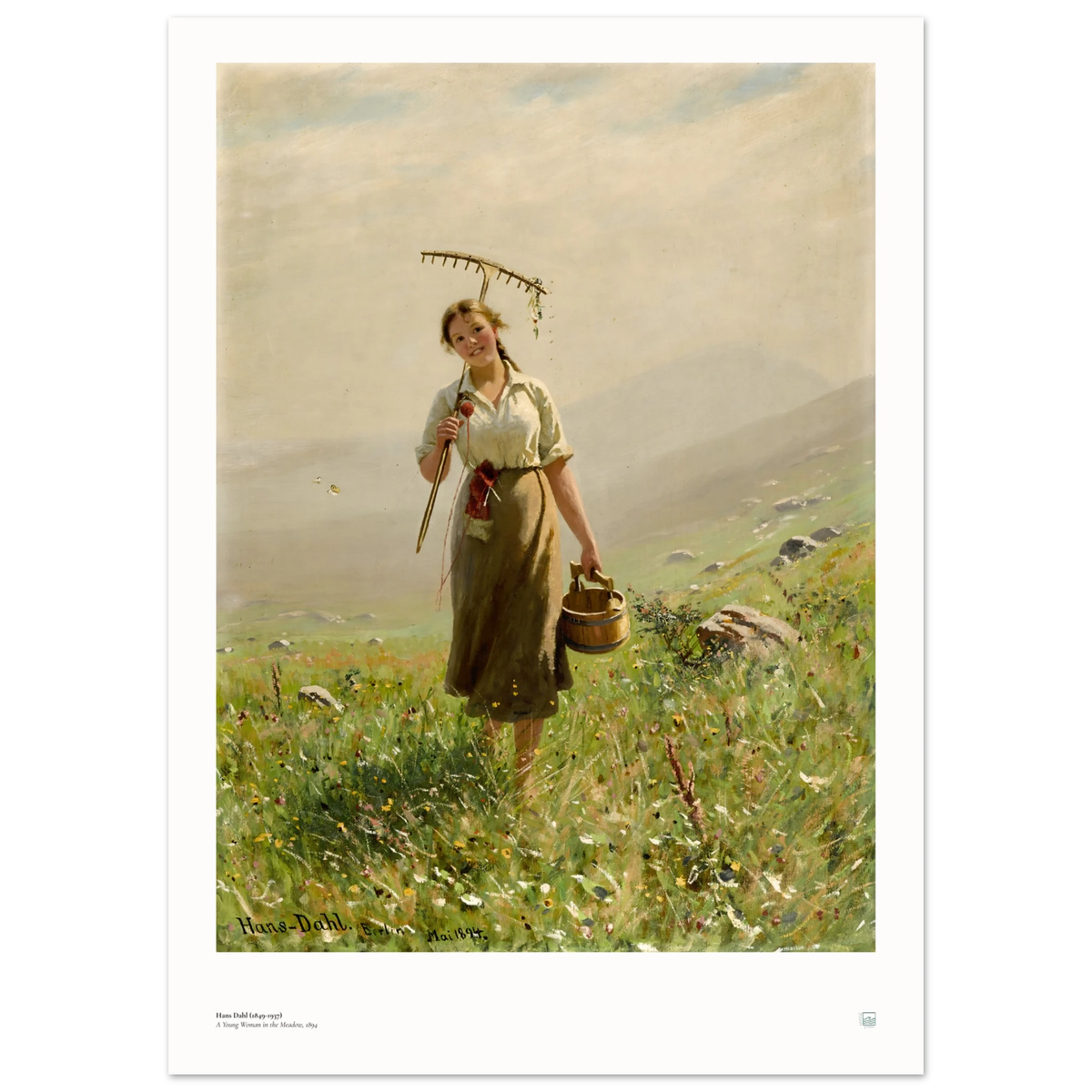 Hans Dahl’s A Young Woman in the Meadow (1894), 50 × 70 cm poster with white border, showing a woman with rake and wooden pail among wildflowers.