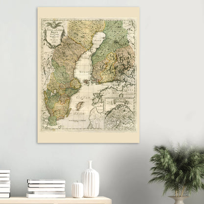 Georg Biurman’s 1747 Sweden and Finland map poster on a light wall above books and white ceramics, beside a green plant.